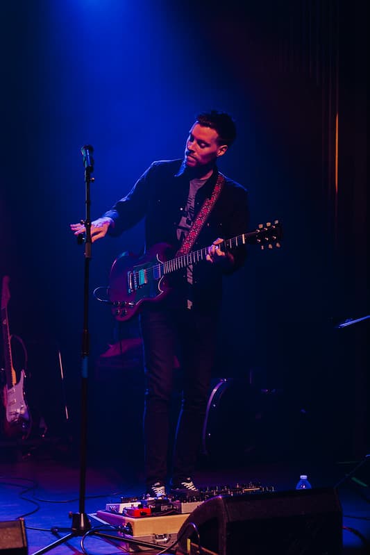 Vocalist giving an energetic performance on a festival stage