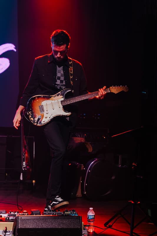 Keyboardist and vocalist harmonizing on stage