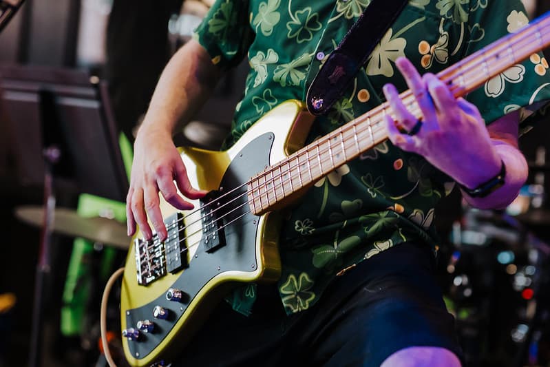 Close-up of bass guitar hands on a Jazz Bass