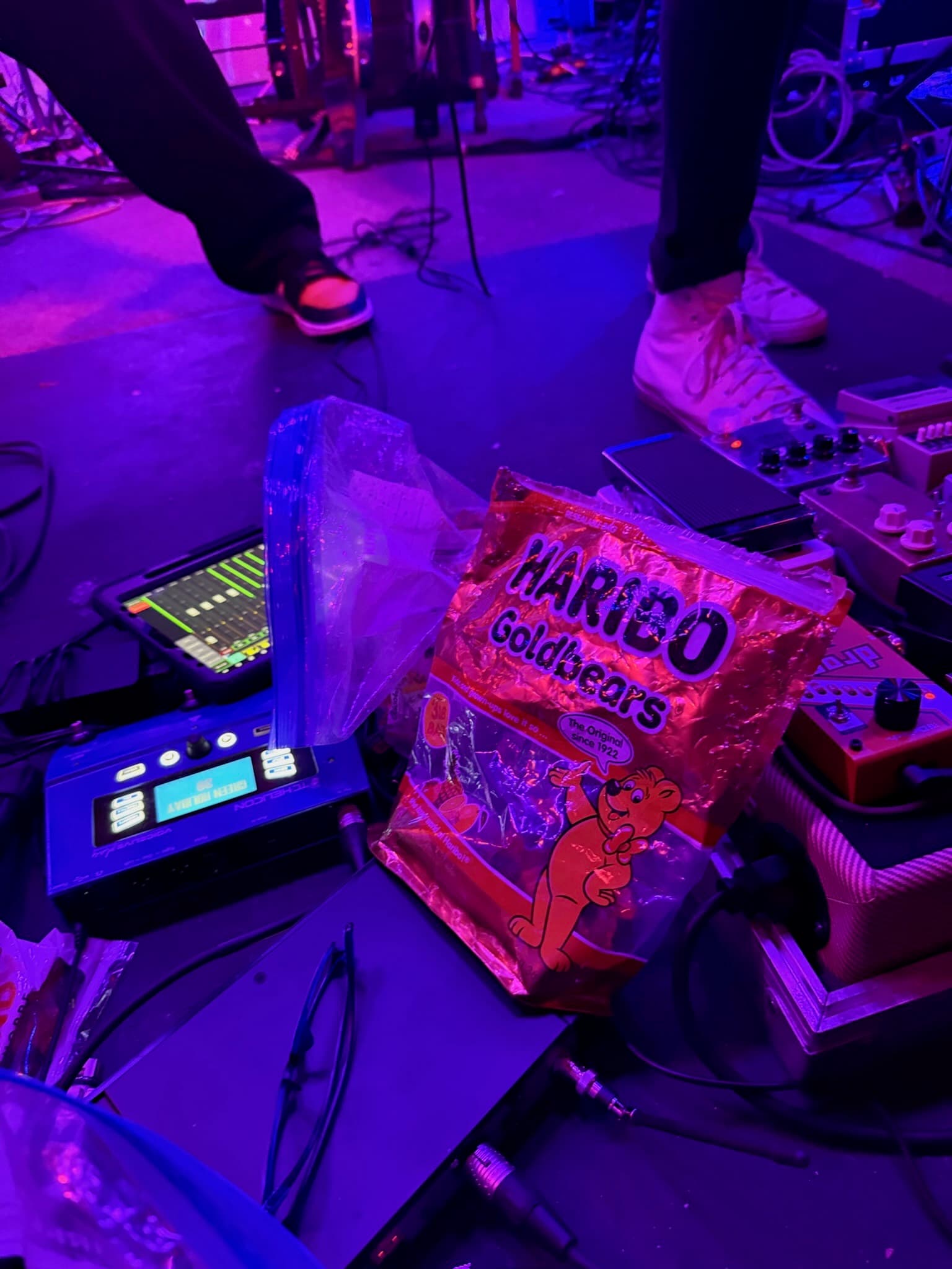 Guitarist mid-solo with stage fog behind