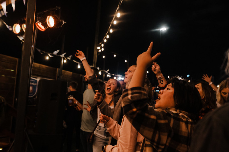 Bassist grooving under purple stage wash