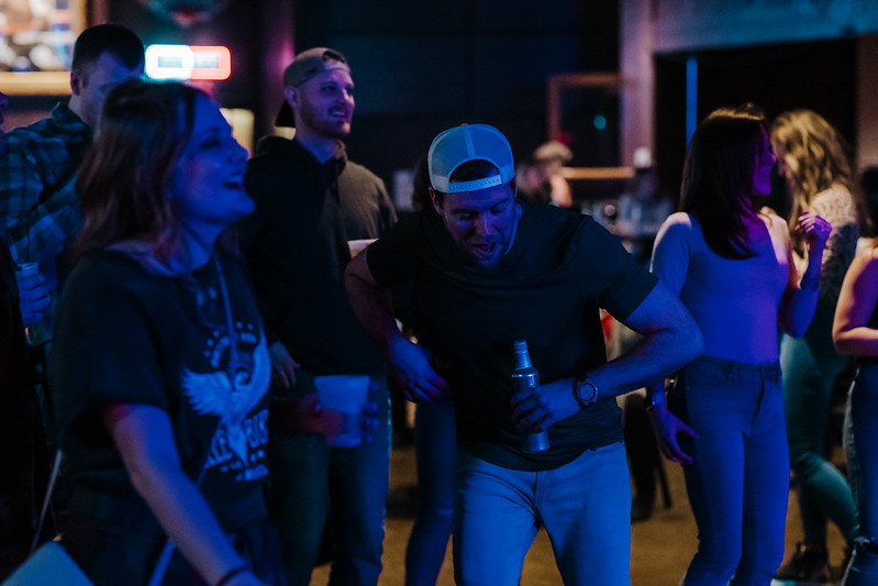 Singer belting out a crowd favorite under warm lights