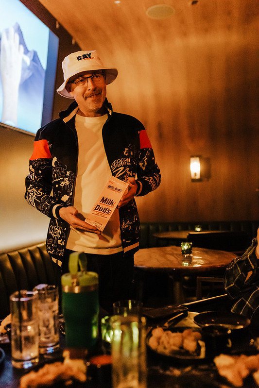 Vocalist silhouetted against vibrant stage lighting