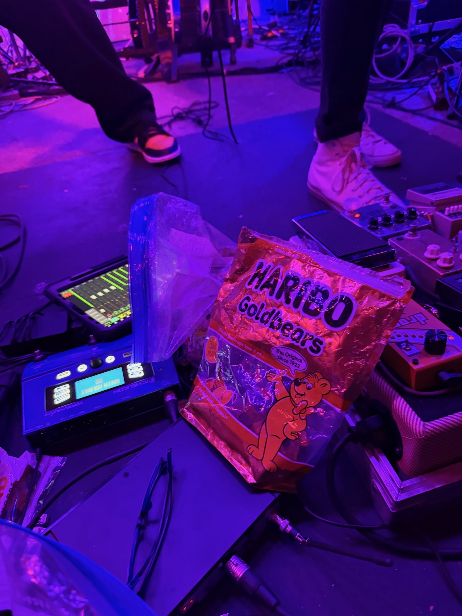 Guitarist mid-solo with stage fog behind
